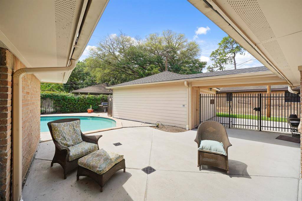 The Backyard features a Wrought Iron Fence and Gate positioned between the Outdoor Patio and the Driveway Area.  A Breezeway is also located between the 2 Car Garage and the House---Bring Groceries and Packages into the House Regardless of Weather!