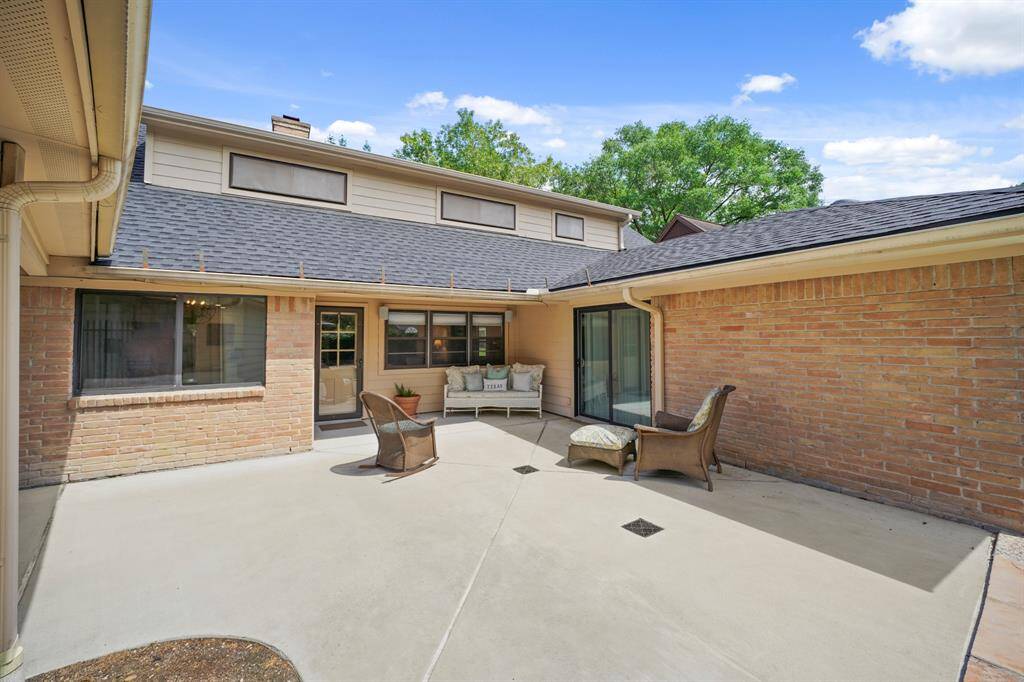 The Oversized Backyard Patio is accessed through a Door from the Living Area and through a Sliding Glass Door in the Primary Suite.
