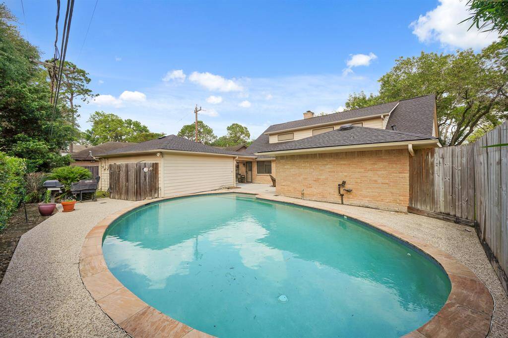 Enjoy Fun Activities in the Sparkling Pool, featuring Flagstone Coping and Pebble Stone Decking.