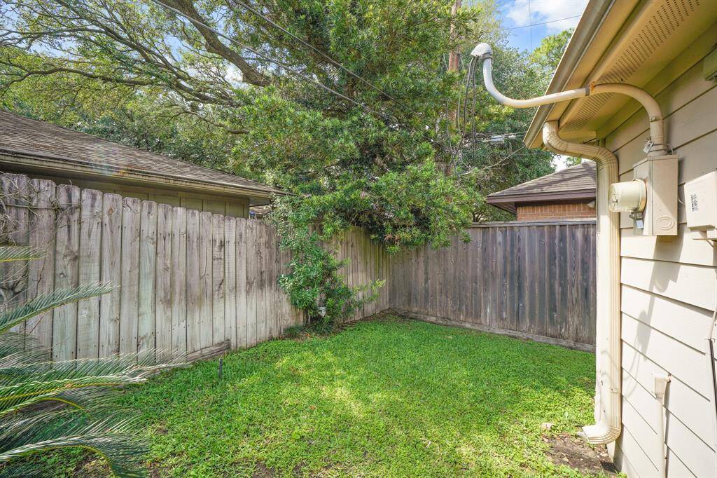 The Fully Fenced Backyard features a Grassy Area for Pets and Kids.