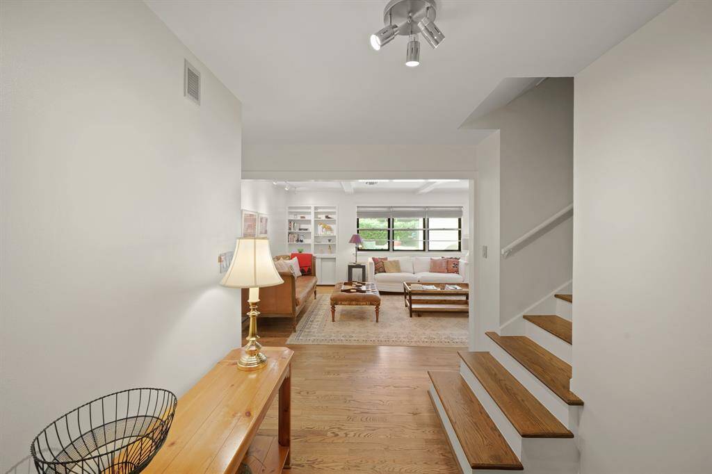 The Foyer features Red Oak Hardwood Floors (2019*), a Polished Nickel Halogen Light Fixture, and Coat Closet. The Stairwell leading to the 2nd Floor EnSuite Bedroom features New Red Oak Steps/Treads (2019*) and New White Risers (2019*) (*per Seller).  A "Texas Sized" Closet (Approximately 19'4" x 7'11") is located at the Top of the Stairs--Amazing Storage Space for your Convenience!  This Closet features Multiple Banks of Built in Shelves and Multiple Hanging Rods. (*per Seller).