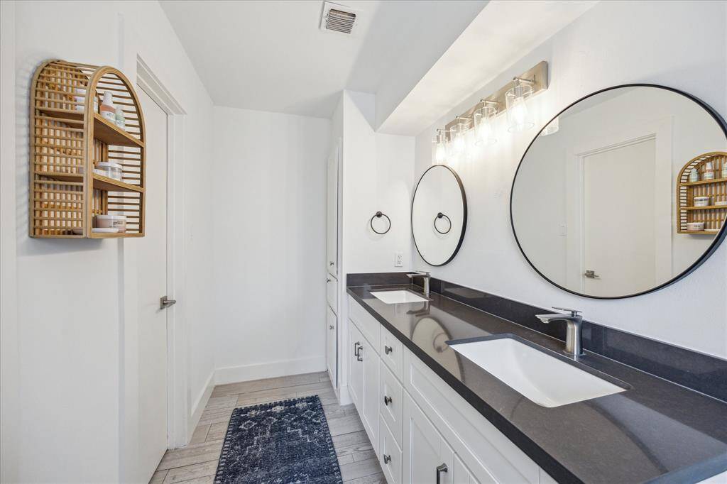 Primary bath features dual sink vanity and framed mirrors.
