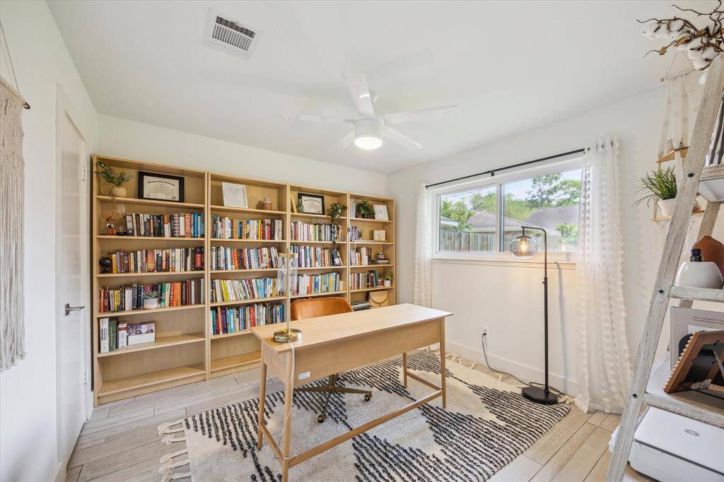 Large secondary bedroom with window that overlooks the backyard.