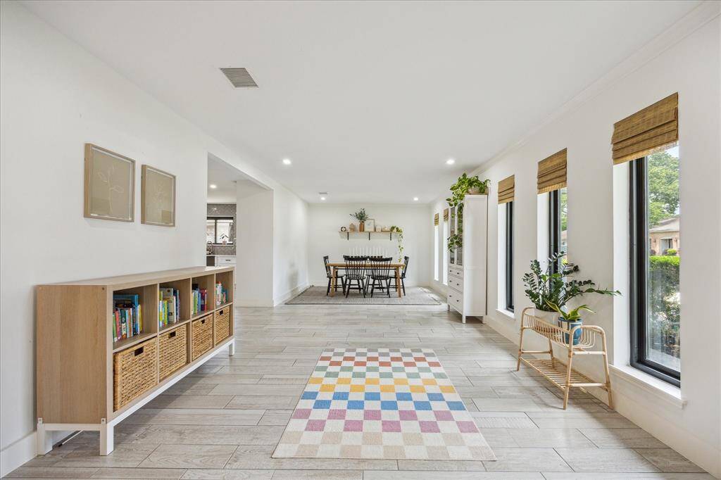 Formal living area open to the formal dining room. Large windows overlook the manicured front lawn.