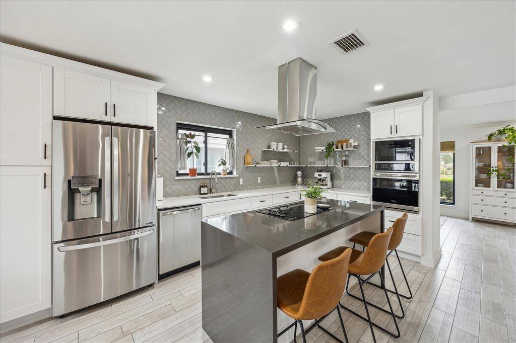 Alternate view of the kitchen equipped with stainless appliances.