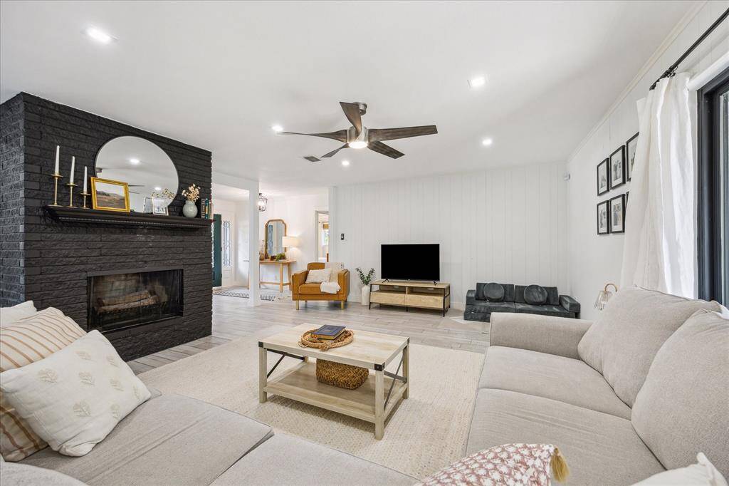 Kitchen is open to the generously sized family room anchored by a fireplace with brick surround.