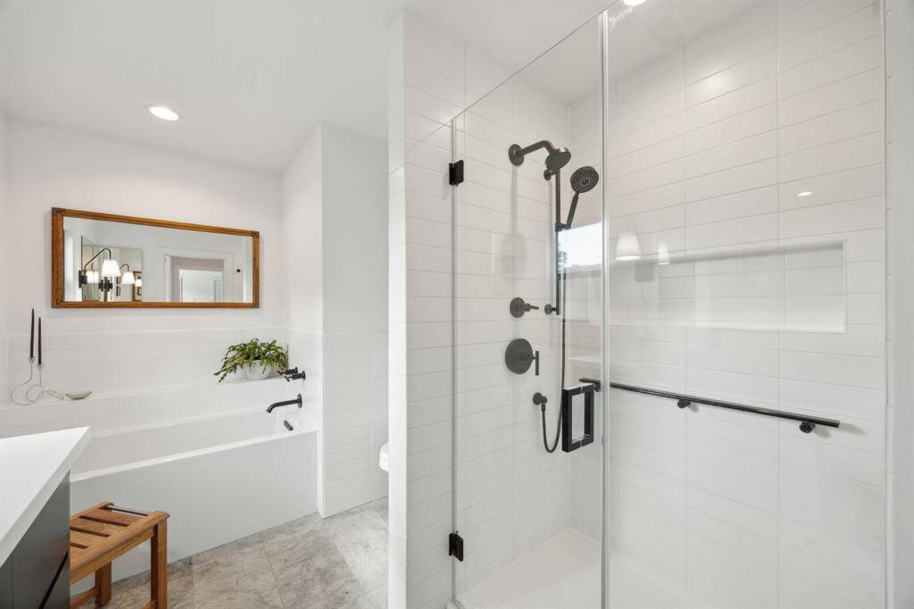 Glass frame shower and soaking tub complete the spa-like primary bath.