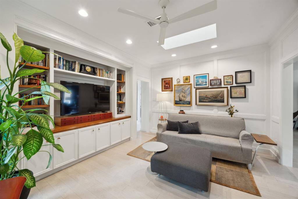 Formerly the third bedroom, the flex room just off the entry provides the perfect spot for an office and sitting area. Gorgeous moldings and skylight enhance this space.
