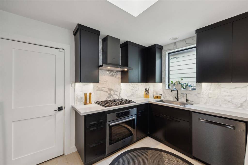 This perspective of the kitchen shows access to the 2 car garage, gas stove top, and top of the line appliances.