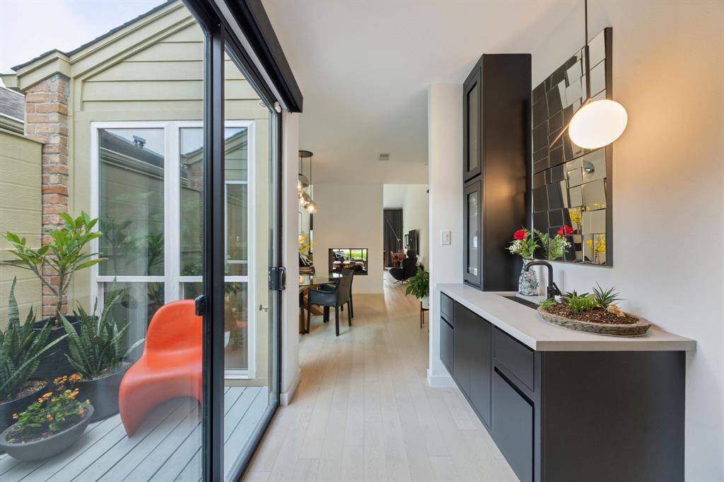 Convenient wet bar is situated between the dining room and kitchen.