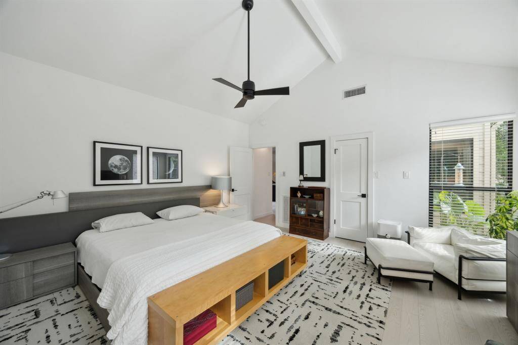 Primary suite boasts vaulted ceiling and three closets.