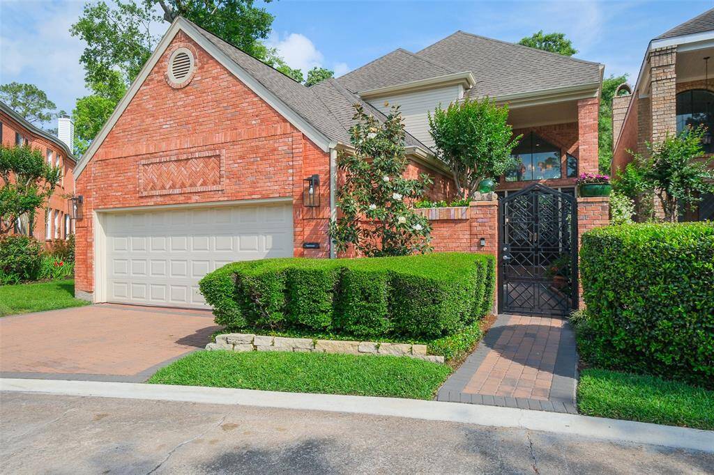 Located in the enclave of Woodlake Forest II, this polished retreat offers timeless curb appeal with its manicured landscaping, double driveway, and custom wrought iron gate.