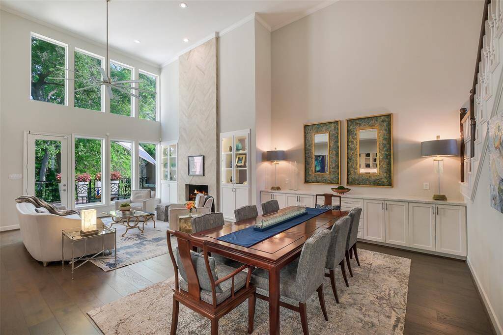 The gracious dining area features a wall of custom cabinetry and designer lighting, creating an upscale yet welcoming setting.