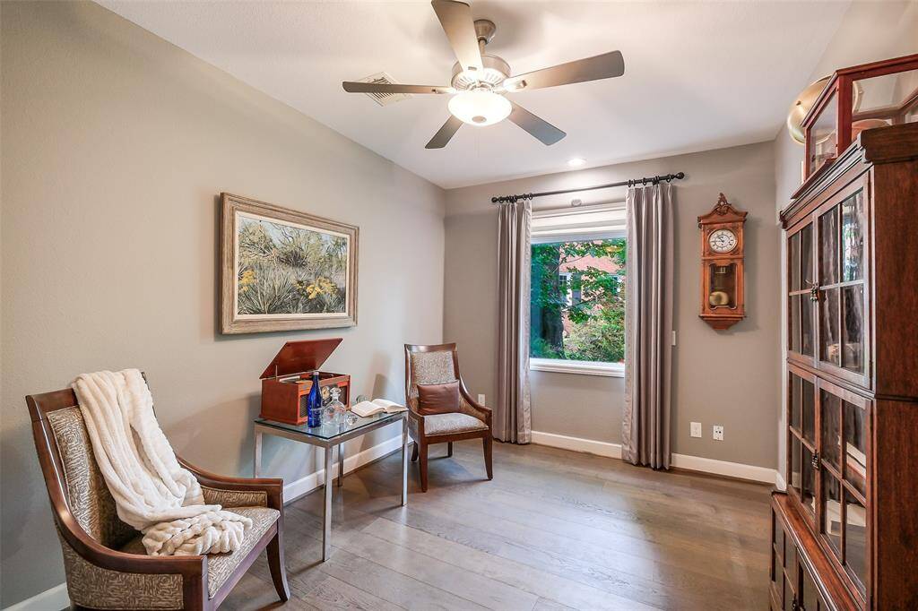 First-floor study or additional bedroom with elegant wood flooring, ample natural light, walk in closet and flexible functionality.