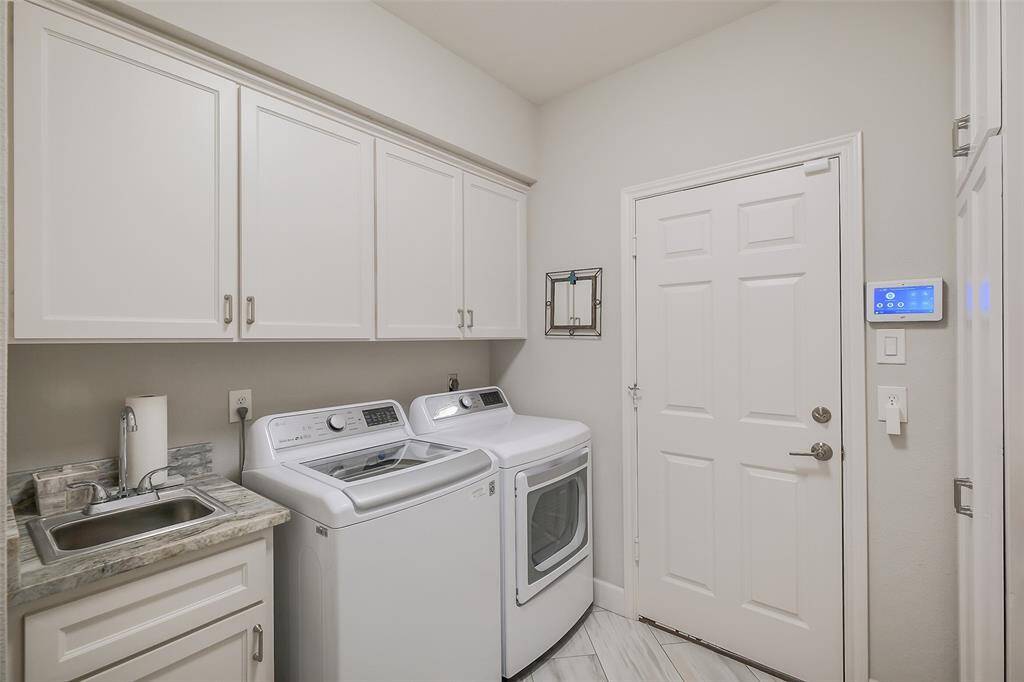 Utility room/laundry room right off the garage with ample storage.
