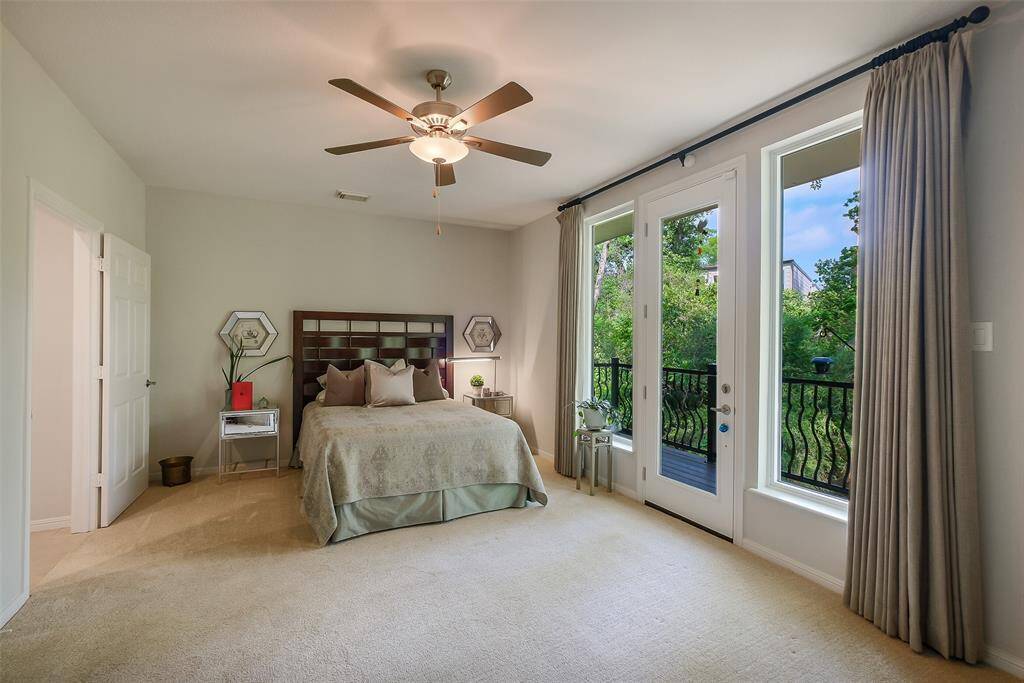 The first-floor primary suite is a peaceful retreat with lush verdant bayou views and direct access to a private deck.
