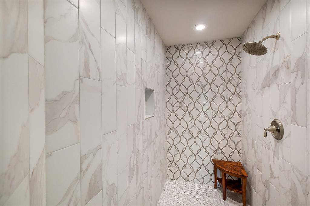 Expansive walk-in shower adorned with statement tilework.