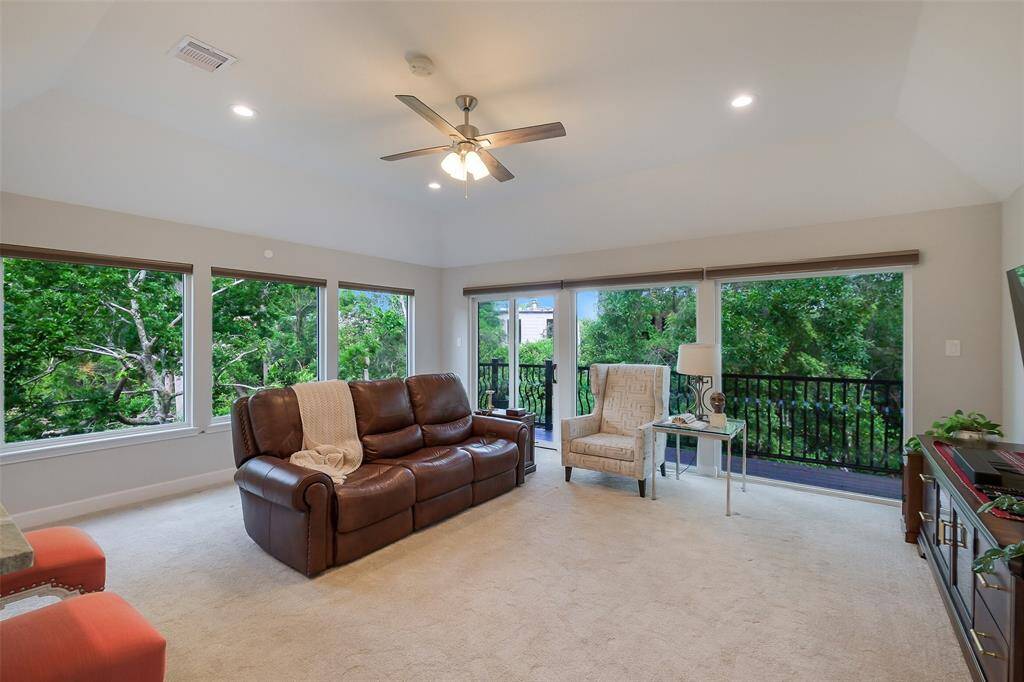Sprawling entertainment lounge or 4th bedroom with two walls of windows, a closet, wet bar and half bath. The view is breathtaking.