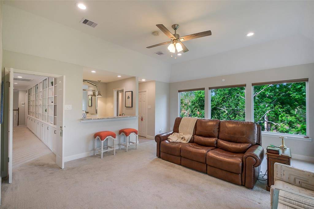 Versatile and bright, this upstairs retreat connects to a private balcony with beautiful greenbelt/bayou views.
