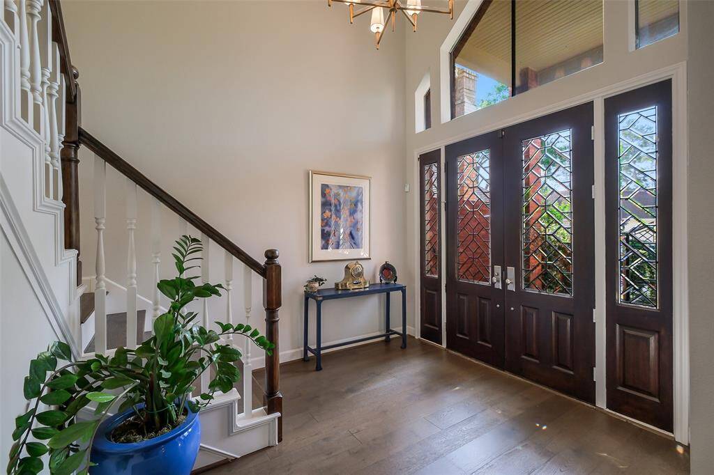 A grand two-story foyer welcomes you with abundant natural light, wide-plank oak floors, and architectural details that set the tone for the rest of the house.