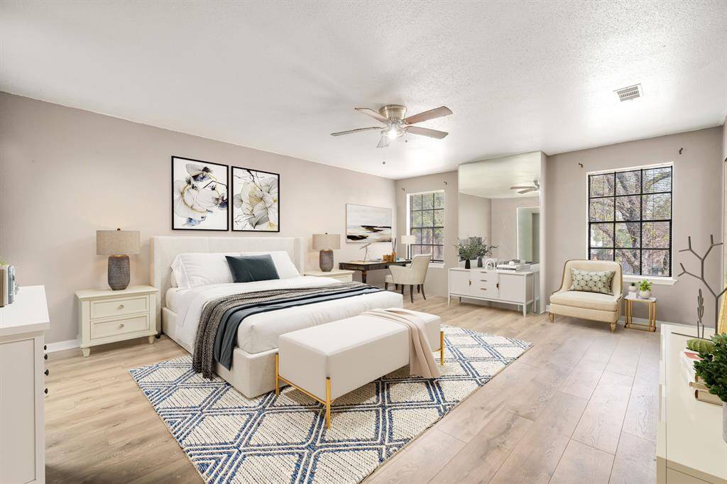 Come and unwind after a long day in this magnificent primary suite! This spacious room features plush carpet, warm paint, sitting area, high ceilings, beautiful custom ceiling fan and large windows with privacy blinds. *Virtually Staged