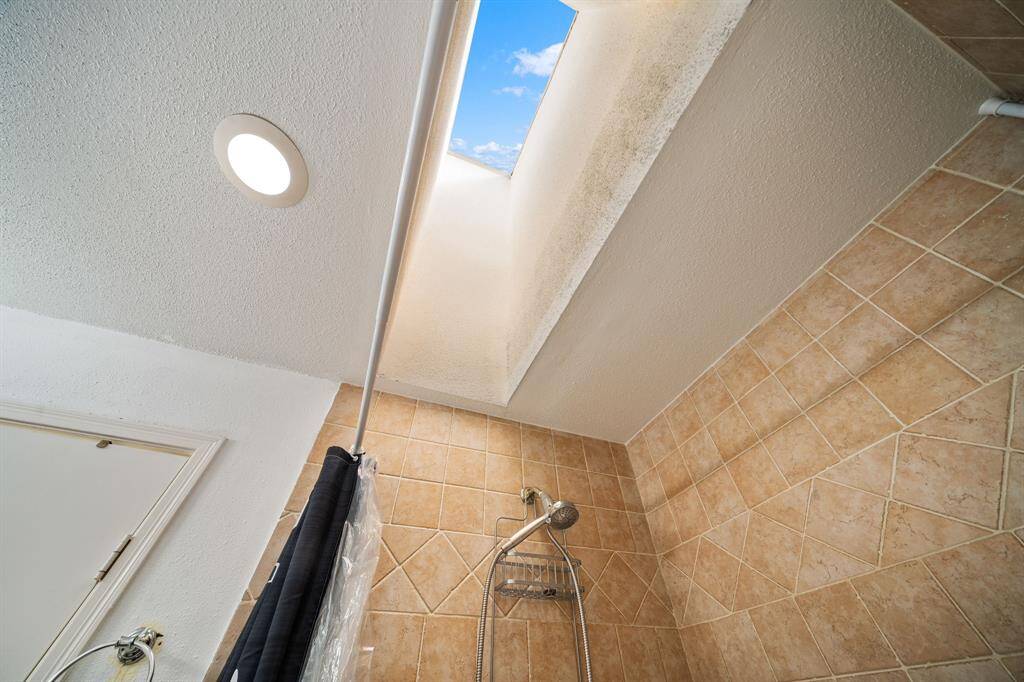 Enjoy a bright, spa-like atmosphere in the primary bath, thanks to this overhead skylight that invites plenty of natural light.