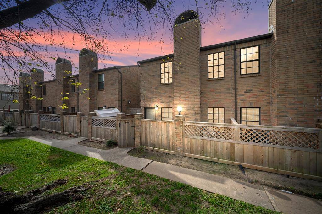 Discover the inviting charm of this two-story brick home, complete with a private fenced courtyard, perfect for relaxing or entertaining.