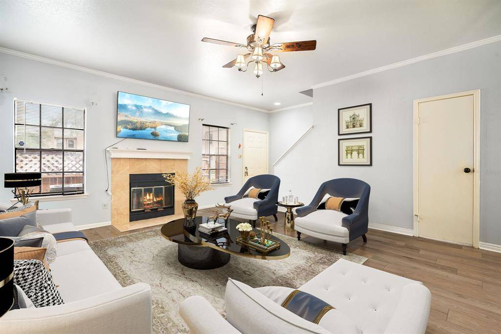 Experience everyday comfort in this inviting living area, highlighted by a cozy fireplace, modern flooring, and plenty of natural light. *Virtually Staged