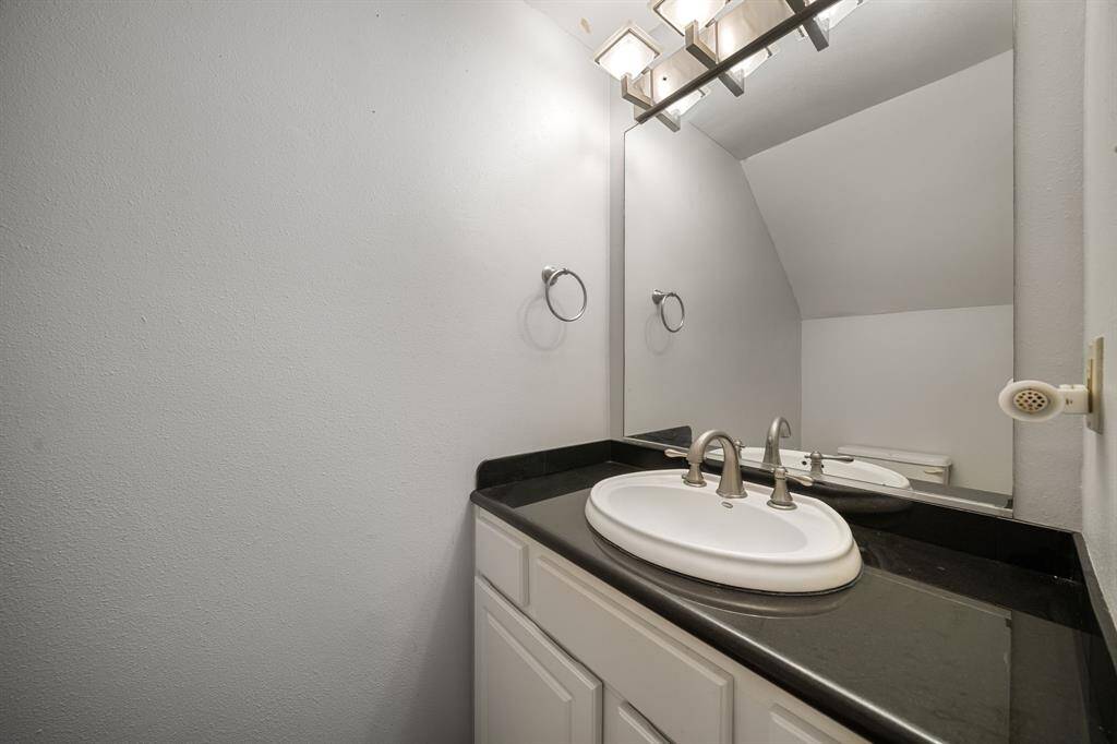 Fresh and functional, this conveniently located half bath features granite counters and updated fixtures, perfect for guests and everyday use