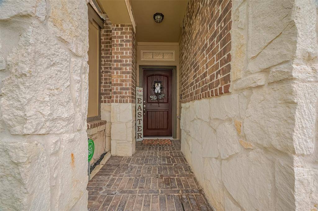 Striking entryway with a beautiful wood front door.