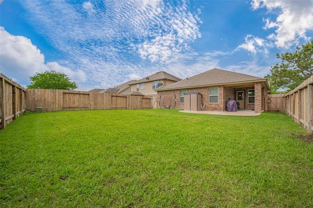 Spacious corner lot, backyard with well-maintained lawn and fenced for privacy, perfect for outdoor gatherings.