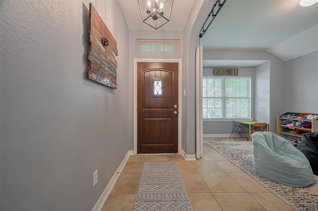 Welcome to a bright entryway with elegant tile flooring.