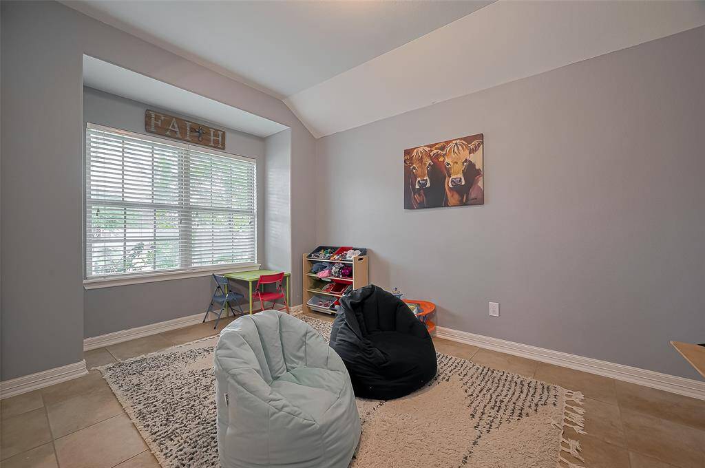 This versatile space, ideal as a formal dining room, is currently set up as a game room.
