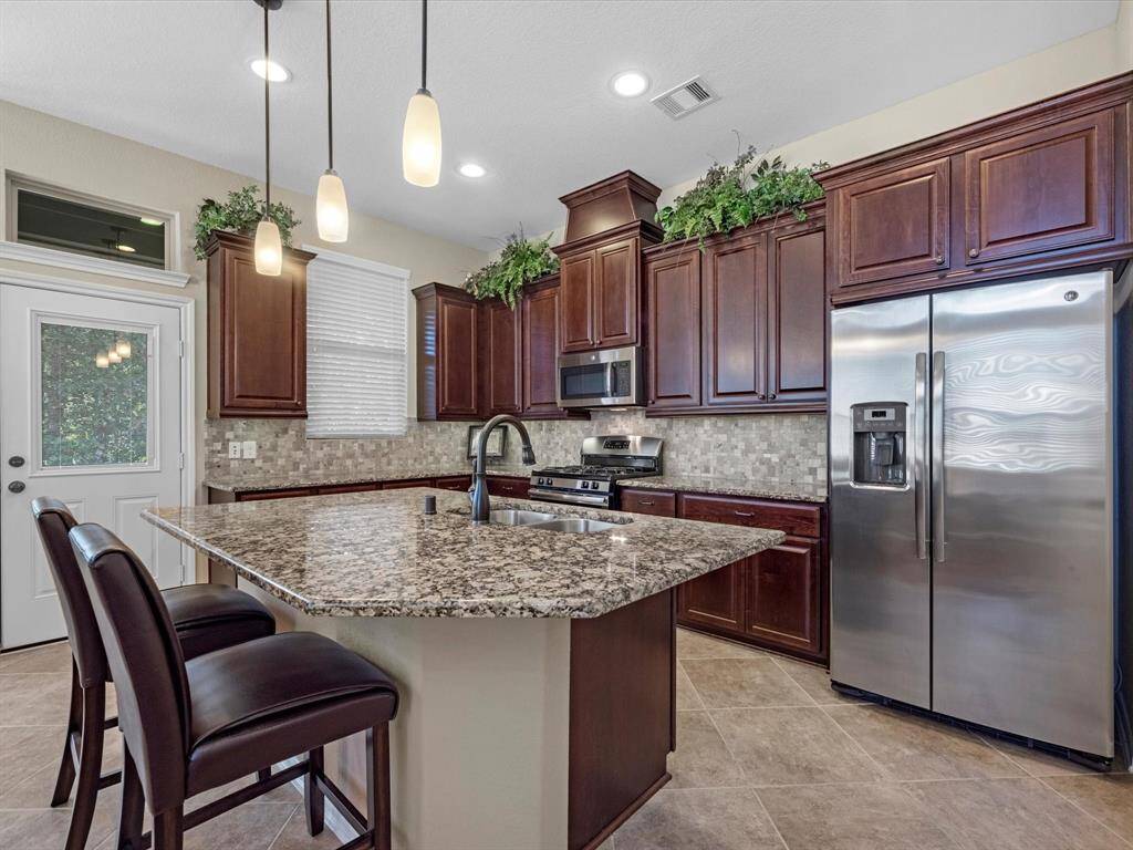 Granite counters, stainless appliances, soft closing drawers, and much more in this gorgeous kitchen!