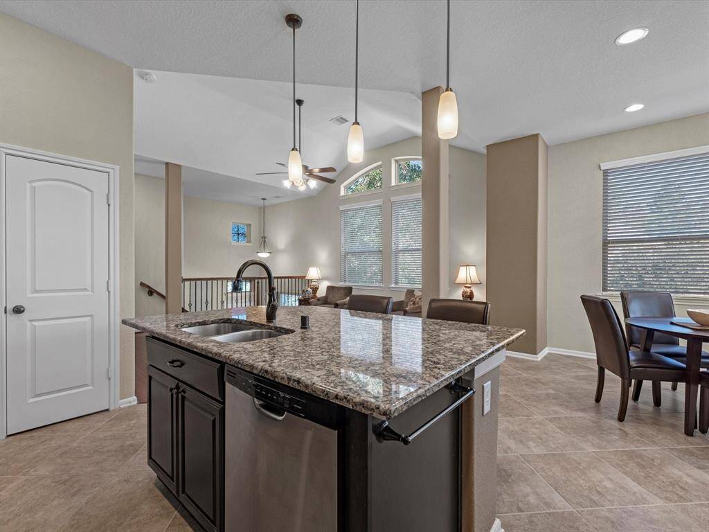 The kitchen is open to the family room, dining area, and leads to outdoor balcony. Perfect for entertaining!