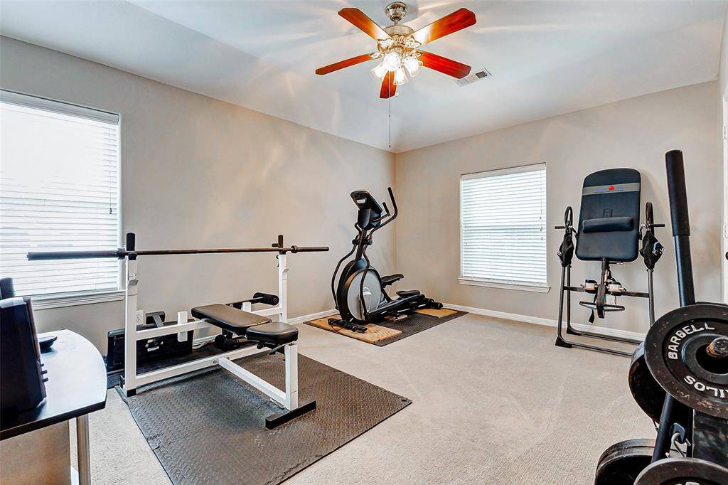 Versatile upstairs bedroom, currently a well-equipped home gym.