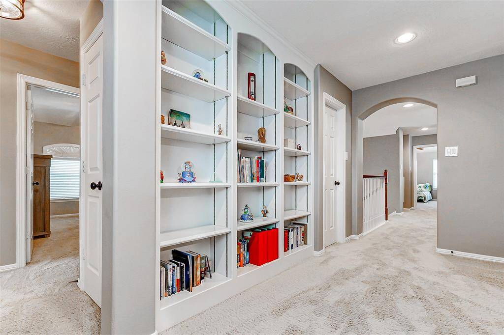 Bright and spacious hallway with built-in shelving.