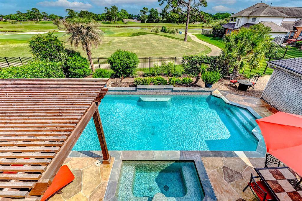 Second floor balcony overlooks a lush golf course, providing a serene and picturesque setting for relaxation and entertainment.