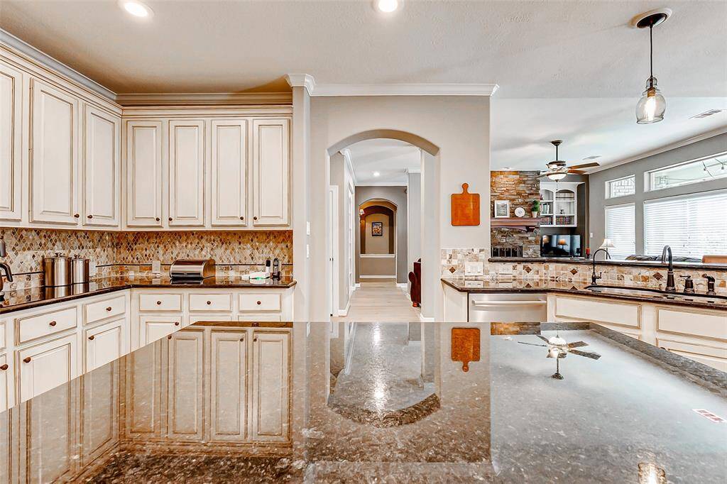 Modern kitchen with elegant cabinetry, granite countertops, and a stylish backsplash. An open layout with plenty of natural light, a large island, and a view into a cozy living area. Perfect for entertaining and family gatherings.