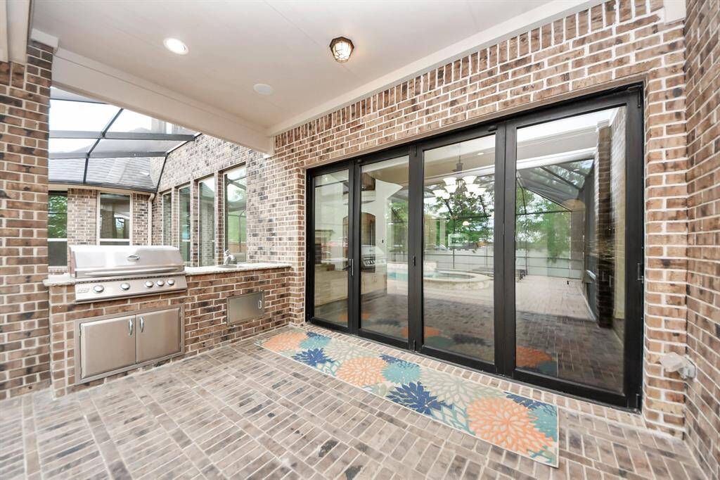 Large covered patio with grill and a sink. Who's ready to eat?