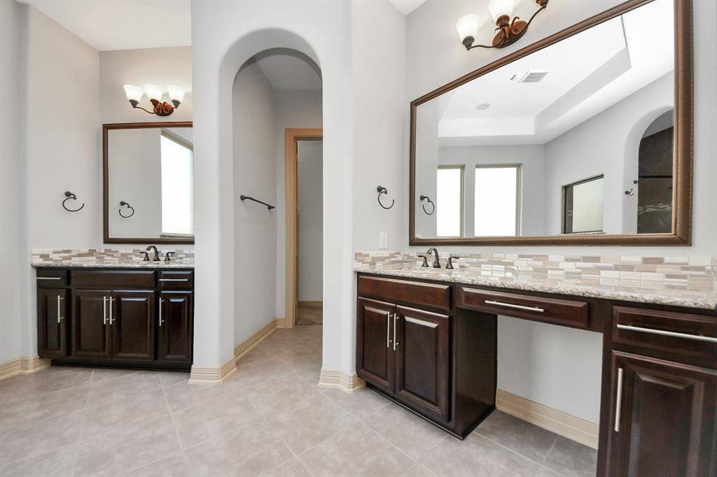 Primary oasis bathroom gives you two separate sinks, large soaking tub and shower and a walking closet