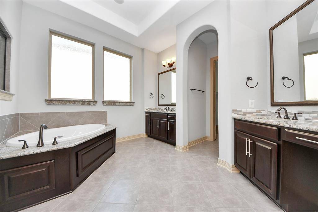 Primary oasis bathroom gives you two separate sinks, large soaking tub and shower and a walking closet