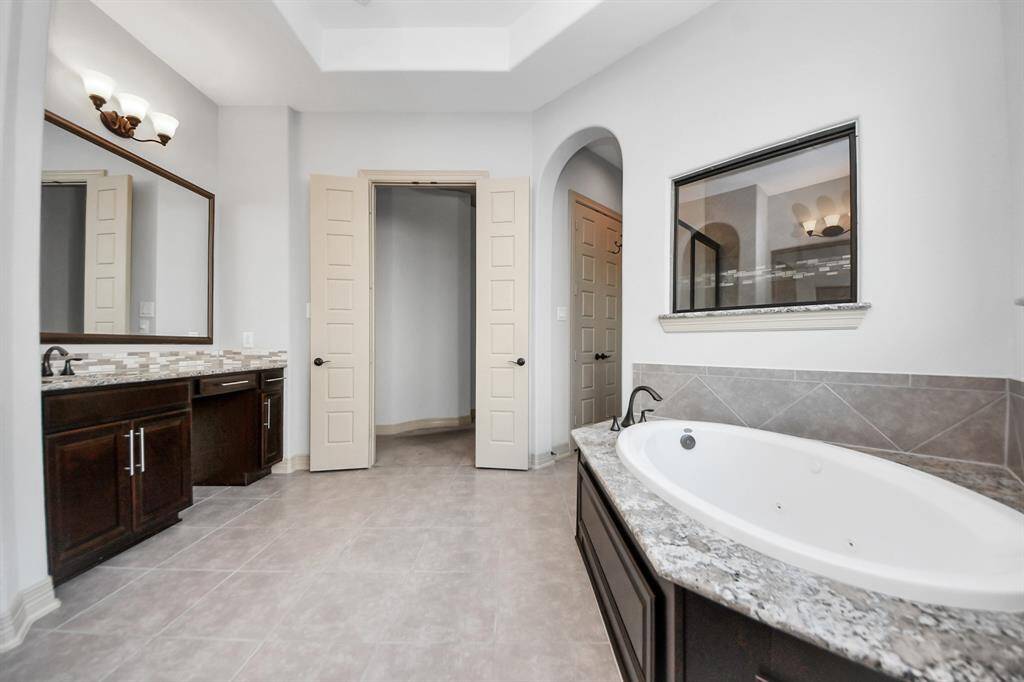 Primary oasis bathroom gives you two separate sinks, large soaking tub and shower and a walking closet
