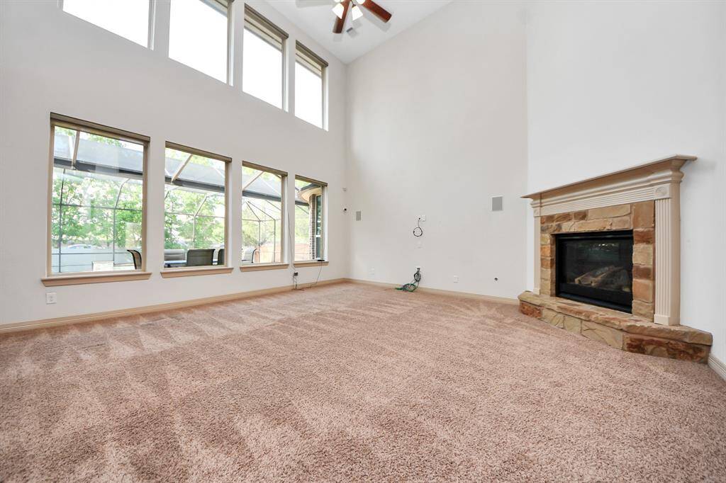 Be presented by a wall of windows that offers views to a stunning backyard oasis