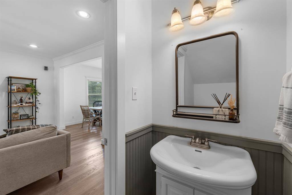 Powder room on the first floor with accent wainscoting