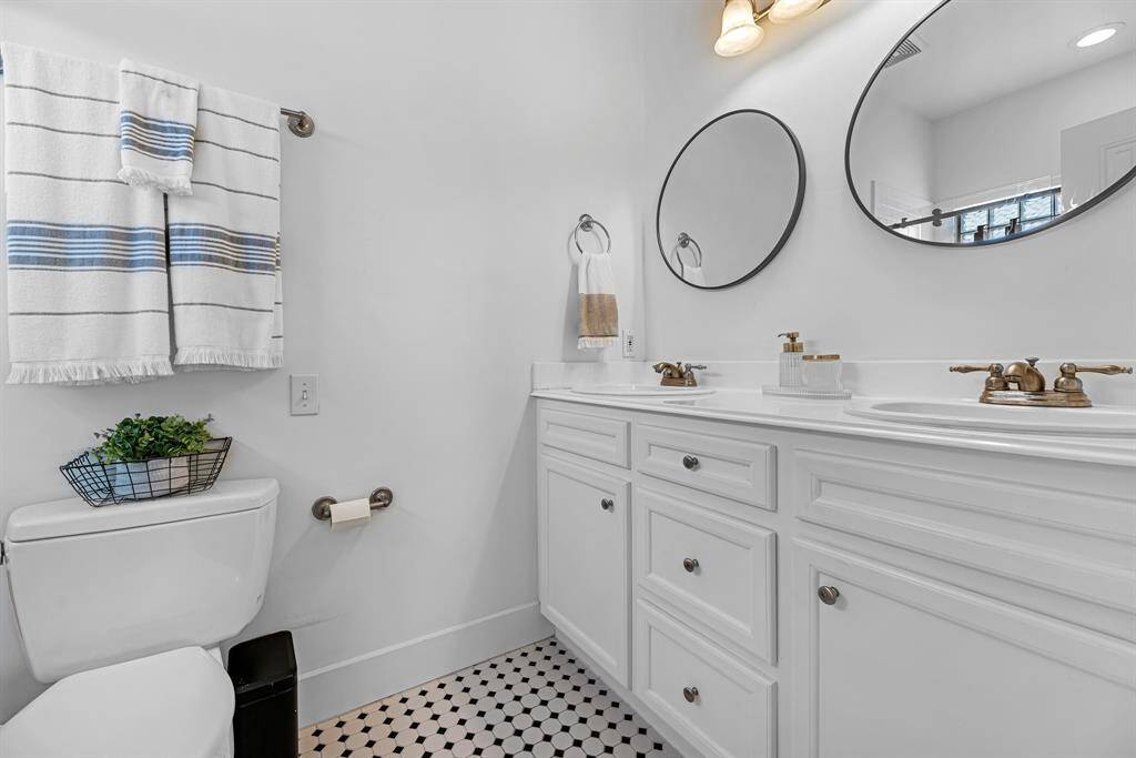 Primary bath with tile floors and double sinks