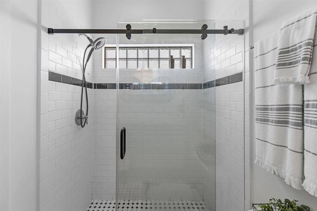 Large shower has sliding glass barn doors
