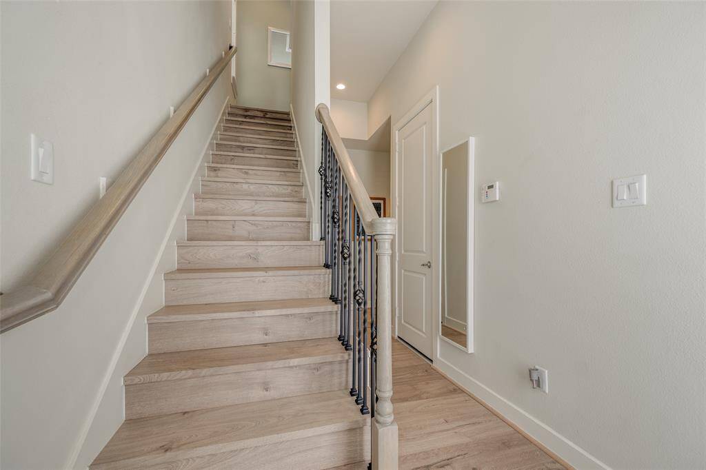 Upstairs to living room, dining room, kitchen & Primary bedroom suite