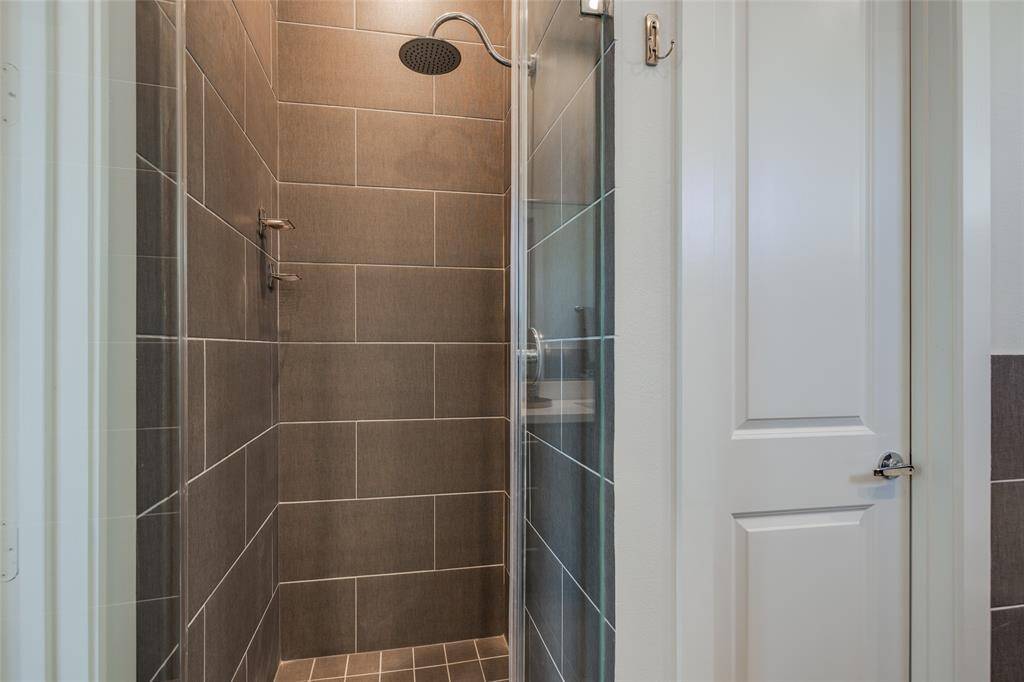 Gorgeous Primary Bathroom with stand alone tube, gray tile floor & shower, beautiful mahogany cabinets, 2 sinks , los of natural light & high ceilings