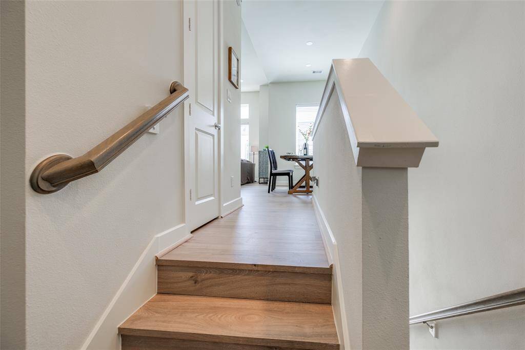 Stairs up to Living room, kitchen & Dining Room, door to half bath